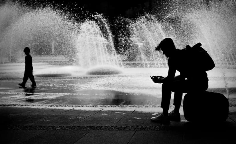 connected disconnected - woman with phone in golden doorway light in palma