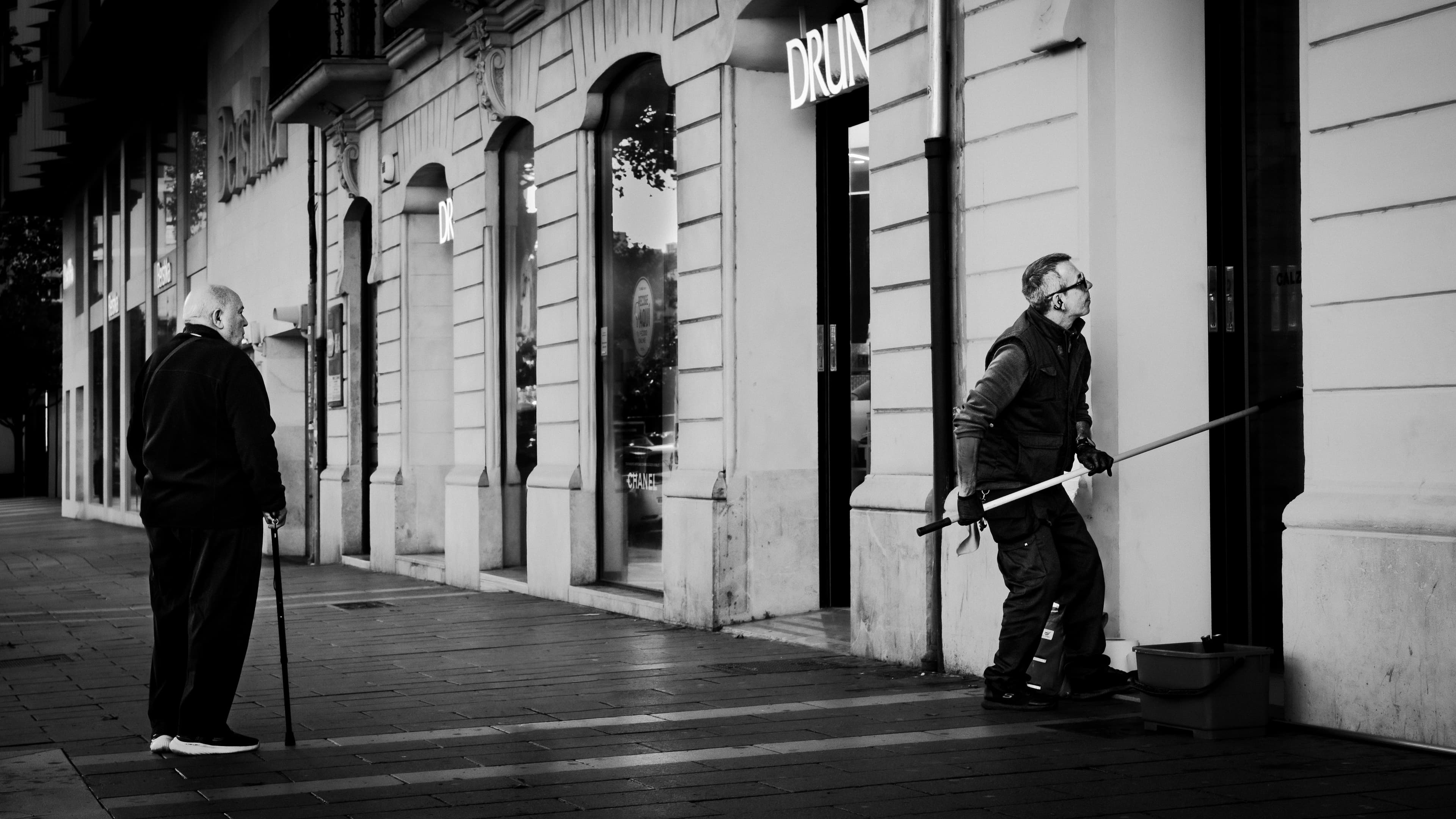 Two elderly men on a Palma street at dawn